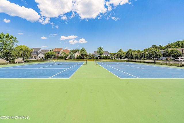 view of tennis court featuring fence