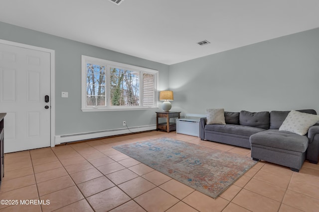 living area featuring visible vents, baseboard heating, and light tile patterned flooring