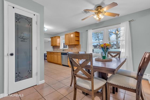 dining room with light tile patterned floors, visible vents, and ceiling fan