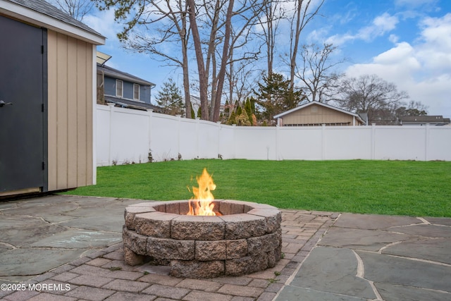 exterior space with an outdoor fire pit and fence