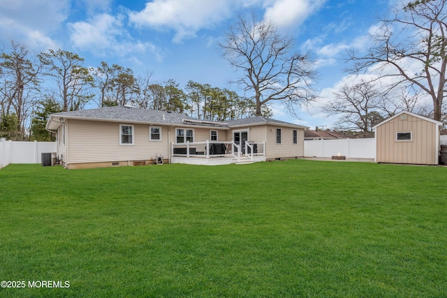 back of house featuring a shed, a lawn, a fenced backyard, an outdoor structure, and crawl space