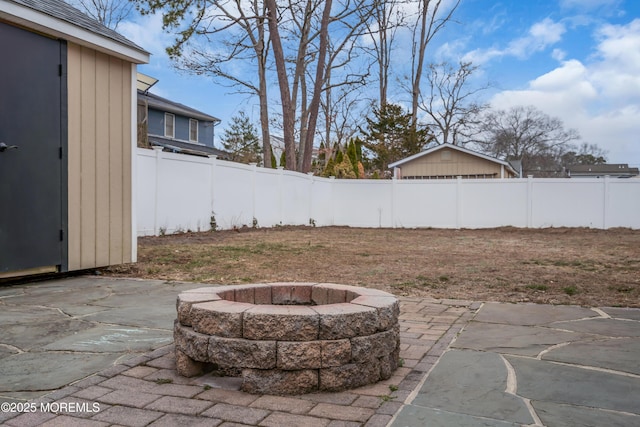 view of yard featuring a patio, a fenced backyard, and an outdoor fire pit