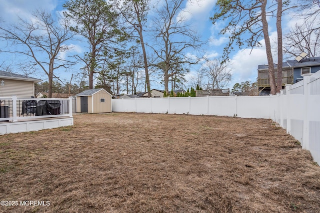 view of yard with a fenced backyard, a storage shed, and an outdoor structure