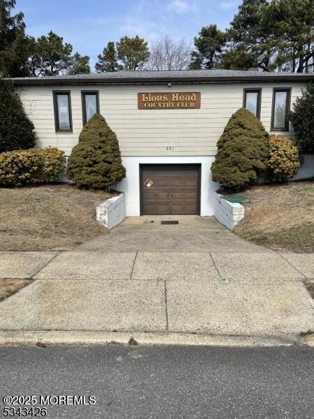 view of front facade with concrete driveway and an attached garage