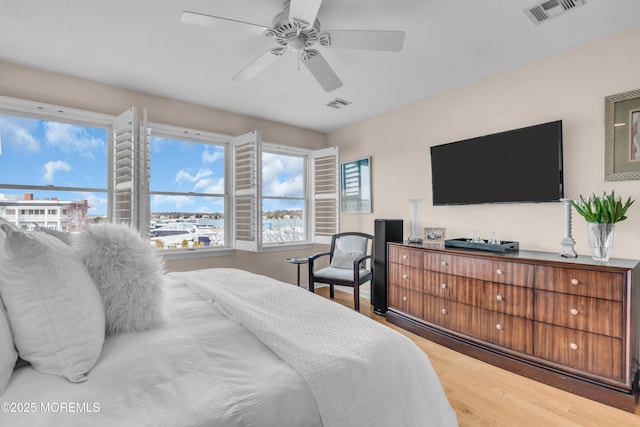 bedroom with visible vents and light wood-style flooring