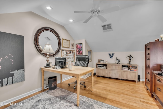 office area with a ceiling fan, baseboards, visible vents, lofted ceiling, and light wood-type flooring