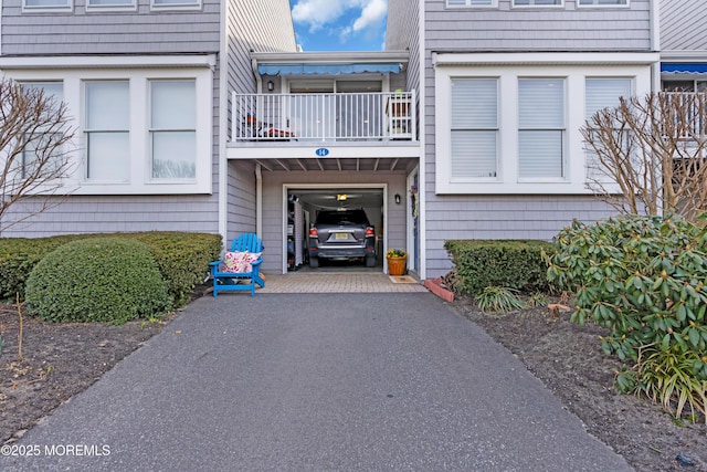 doorway to property featuring aphalt driveway and a balcony