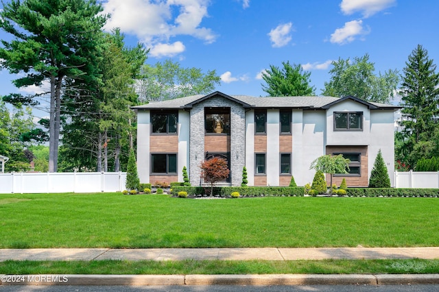 view of front of house featuring a front yard and fence