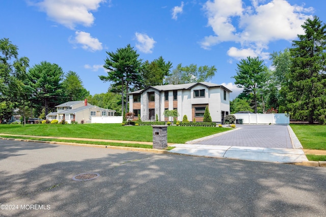 view of front of property with a front yard and fence