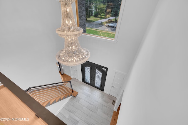 foyer with a chandelier, french doors, and stairs