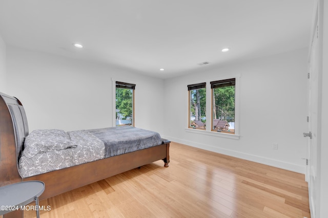 bedroom with recessed lighting, baseboards, and wood finished floors