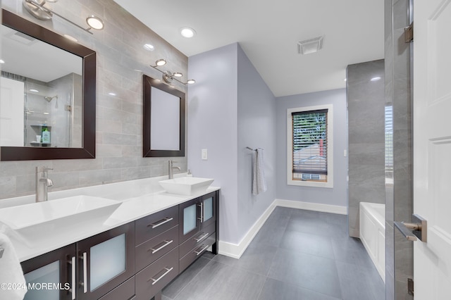 full bathroom with a sink, visible vents, walk in shower, and double vanity