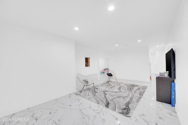 interior space featuring recessed lighting, marble finish floor, and baseboards