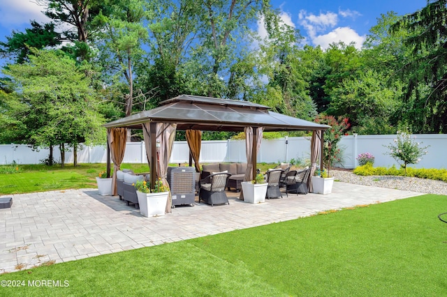 view of patio with a gazebo, an outdoor hangout area, and a fenced backyard