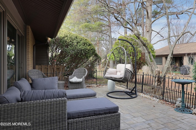 view of patio / terrace featuring outdoor lounge area and fence