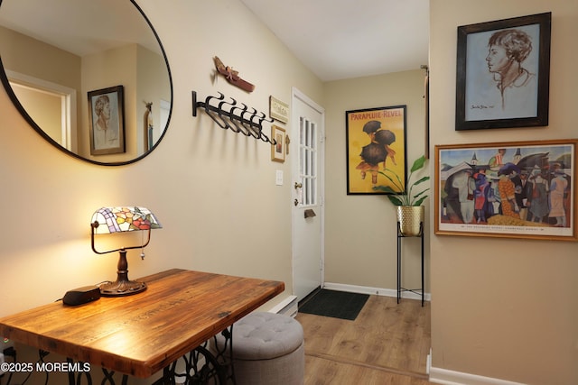 foyer entrance with wood finished floors and baseboards