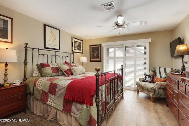 bedroom with access to outside, visible vents, light wood finished floors, and ceiling fan