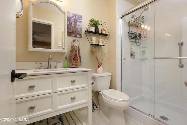 full bathroom featuring tile patterned floors, toilet, a stall shower, and vanity