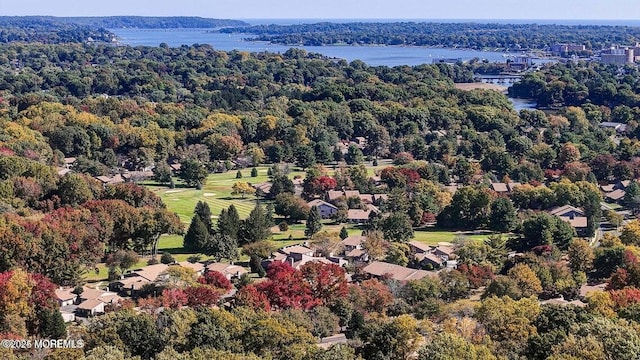 drone / aerial view featuring a forest view and a water view