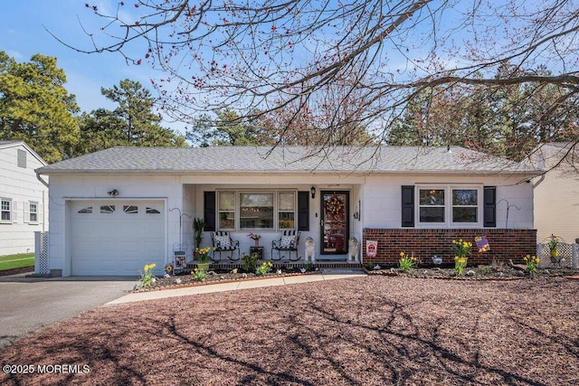 ranch-style home featuring brick siding, a garage, and driveway