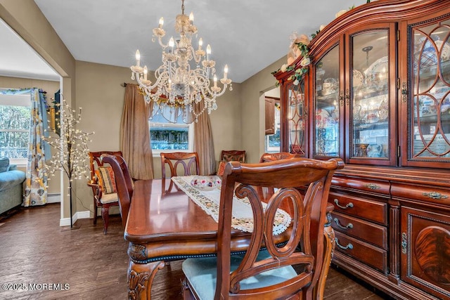 dining space with a chandelier, baseboards, and dark wood-style floors