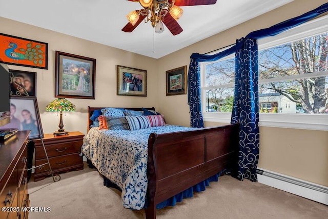 bedroom with a ceiling fan, baseboard heating, and carpet flooring