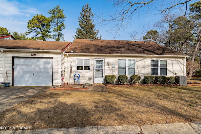 ranch-style home with a front lawn, cooling unit, a garage, and driveway