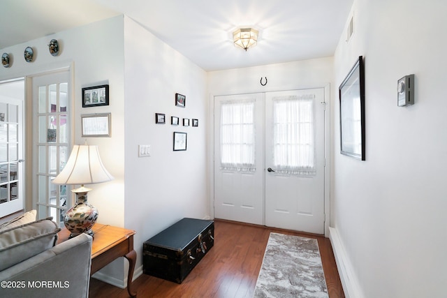 entryway with visible vents, french doors, baseboards, and wood finished floors