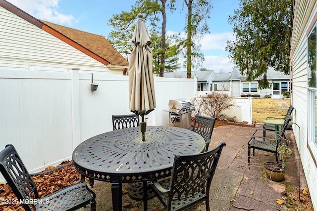 view of patio featuring area for grilling and fence