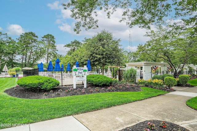 view of playground featuring a yard and fence