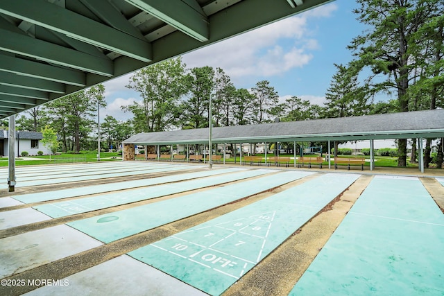 surrounding community featuring a lawn and shuffleboard