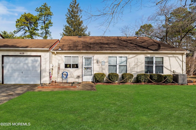 single story home with central air condition unit, an attached garage, a front lawn, and aphalt driveway