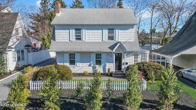 view of front of home featuring a fenced front yard and a chimney