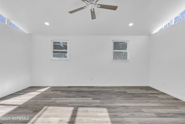 spare room with recessed lighting, a ceiling fan, baseboards, and wood finished floors