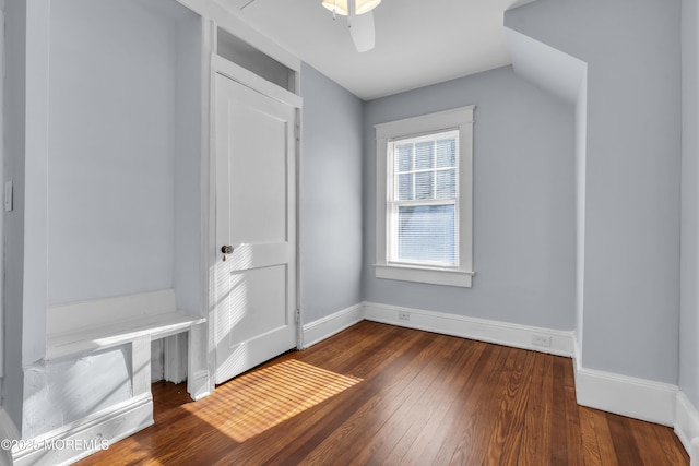 interior space featuring a ceiling fan, baseboards, and hardwood / wood-style floors