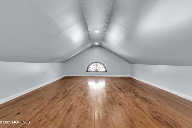 bonus room featuring baseboards, lofted ceiling, and wood-type flooring