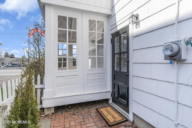 view of exterior entry with fence