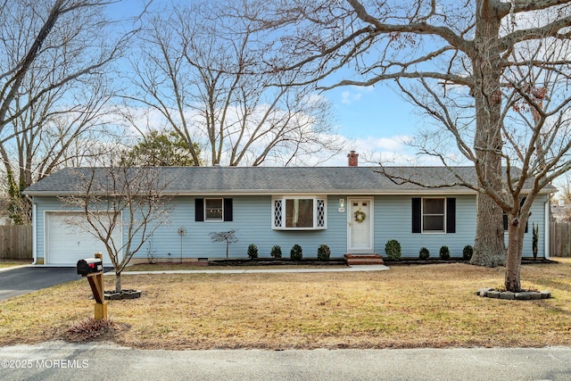 ranch-style house featuring a front yard, fence, driveway, a chimney, and a garage