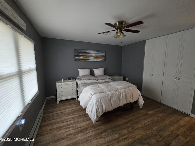 bedroom featuring a ceiling fan and dark wood-style flooring