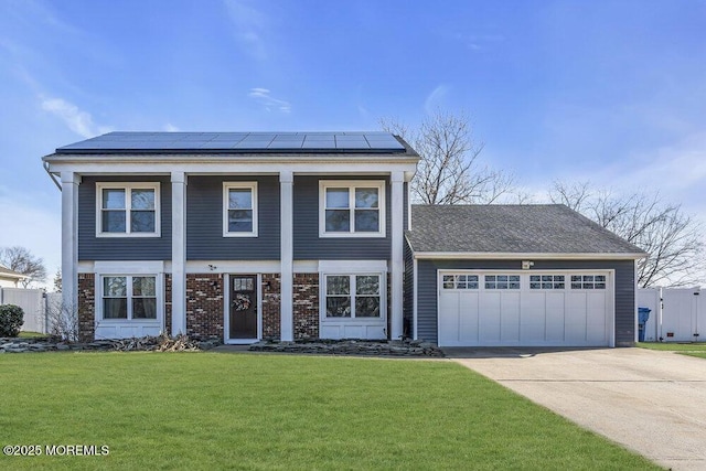 view of front of property with brick siding, solar panels, a front lawn, concrete driveway, and an attached garage