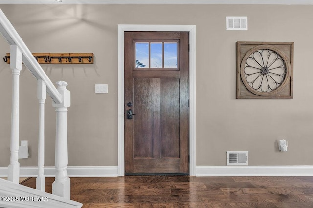 foyer entrance featuring stairs, wood finished floors, visible vents, and baseboards