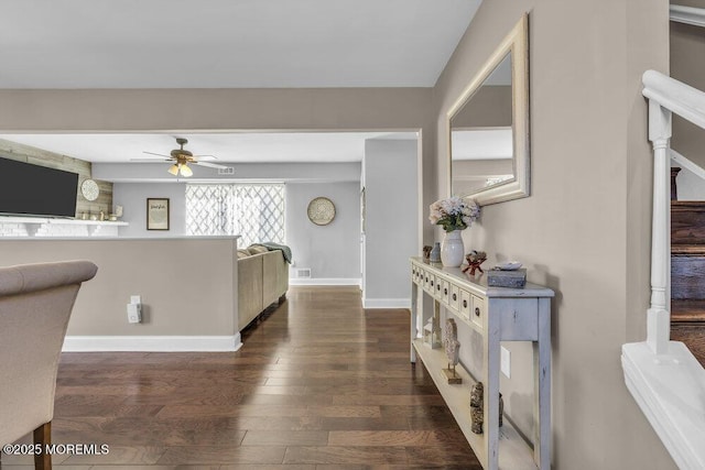 hallway featuring baseboards and wood finished floors