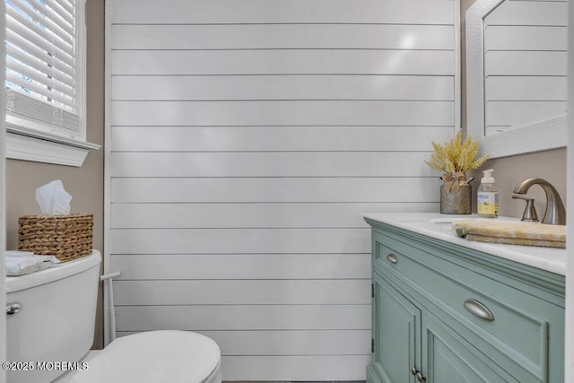 bathroom featuring toilet and vanity