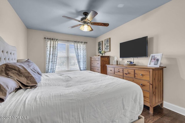 bedroom featuring a ceiling fan, baseboards, and dark wood-style flooring