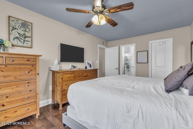 bedroom featuring a ceiling fan, dark wood-style floors, baseboards, and ensuite bathroom