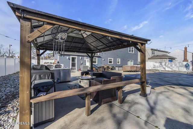 view of patio / terrace featuring a gazebo, a fire pit, and a fenced backyard