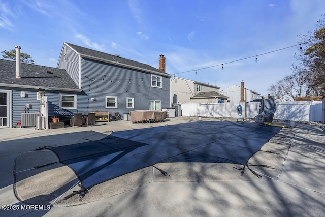 exterior space featuring a fenced in pool, a patio, central AC, and fence