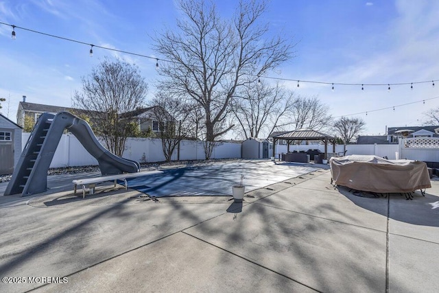 exterior space with a gazebo, a fenced backyard, and a patio area