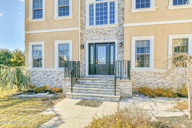 2 Kristen Ct, Franklin Twp, NJ 08873 - view of exterior entry featuring stone siding and stucco siding