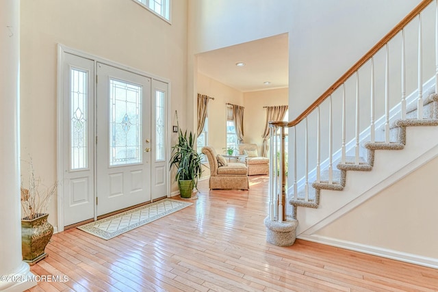 2 Kristen Ct, Franklin Twp, NJ 08873 - foyer entrance with stairway, a high ceiling, baseboards, and hardwood / wood-style flooring